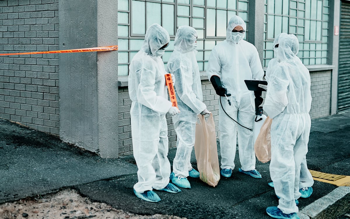 Biohazard response team in hazmat suits arriving at a property